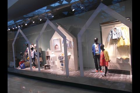 The outline of a house gable is used as the basis for this Marks & Spencer window, which is devoted for the most part to childrenswear and items that kids might need.